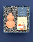 Self-care gift box featuring a coral double-gourd vase, handcrafted lavender soap, and sea salt shower steamer.
