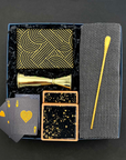 The Cocktail Hour Gift Box with gold bar tools, herringbone towel, coasters, trivia game, and playing cards