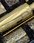 Luxury cocktail gift set with mixology tools, elegant glasses, and sweet treats