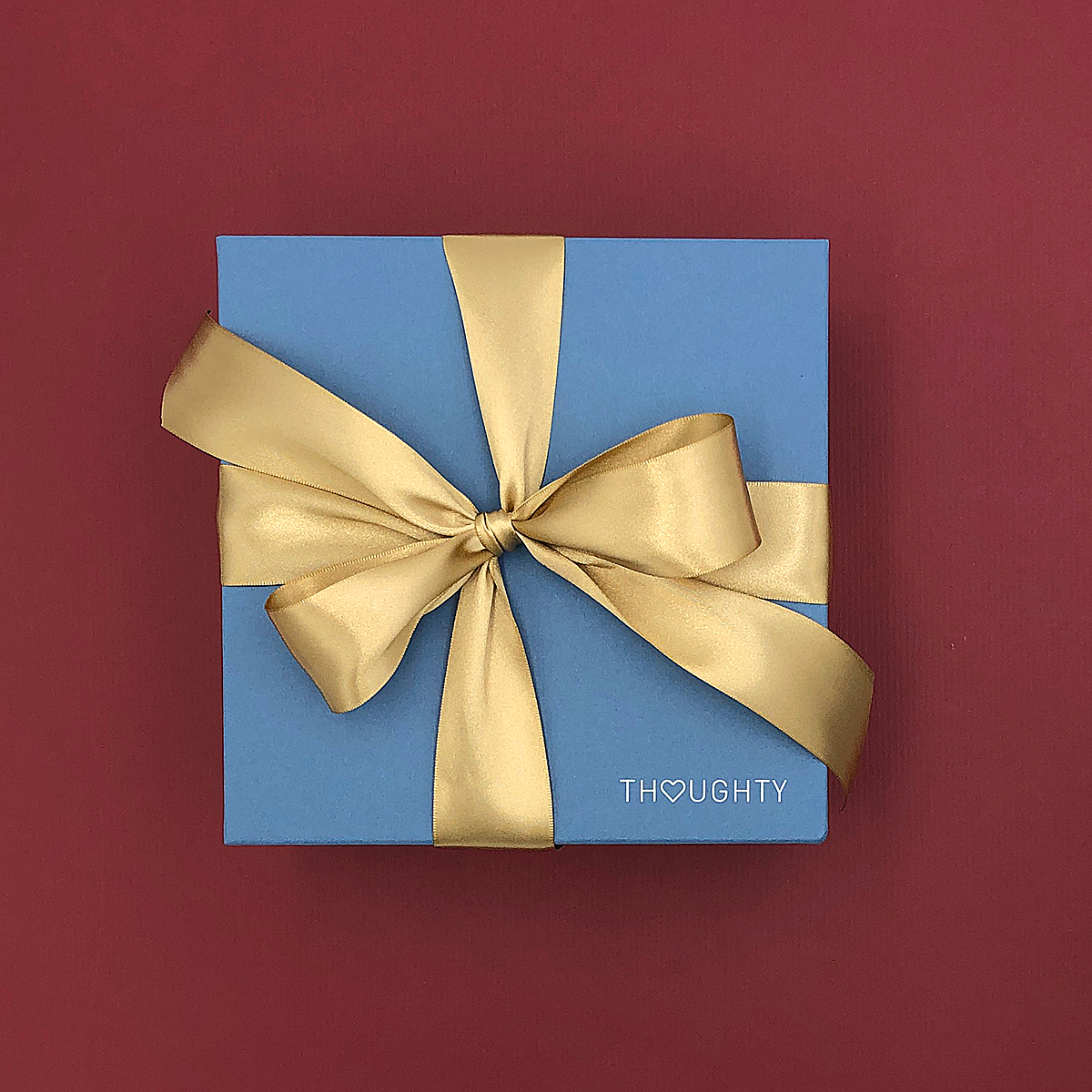 Elegant Winter White Gift Box tied with a satin ribbon, perfect for holiday gifting.