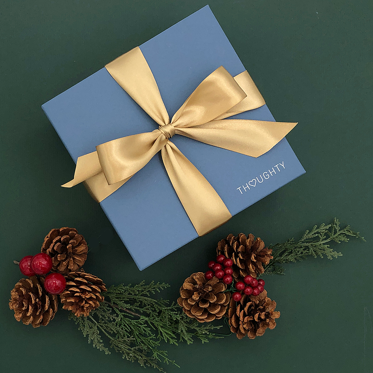 Holiday Raise a Glass Gift Box featuring keepsakes and gourmet sweets.