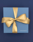 Thoughty gift box with gold atin ribbon.