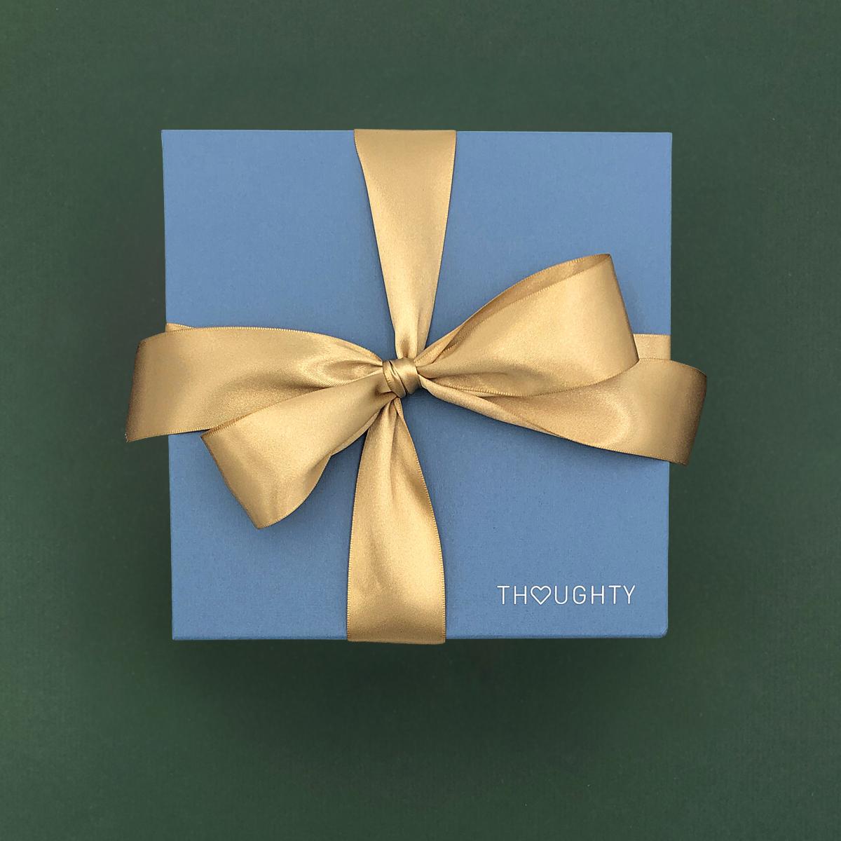 Thoughty gift box with a gold satin bow