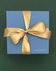 Thoughty gift box with a gold satin bow