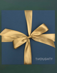 Thoughty gift box tied with a gold satin ribbon.