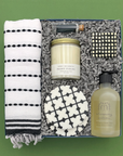 Thoughtful gift for new homeowners with candle, hand towel, soap, coasters, and candy