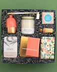 Elegant gift for hosts or housewarmings featuring vase, candle, gourmet treats, coasters, and soap