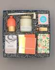 Host Gift Box with coral bud vase, Peony Fields candle, foiled coasters, cookies, Champagne Bubbly Bears, and oatmeal soap