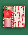 Christmas hostess gift with hand-printed candy cane towel, Peppermint Twist candle, trivia game, colorful matches, and old-fashioned peppermint stick.