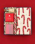 Jolly Holiday Christmas gift box with candy cane kitchen towel, peppermint candle, holiday trivia, matches, and peppermint stick.