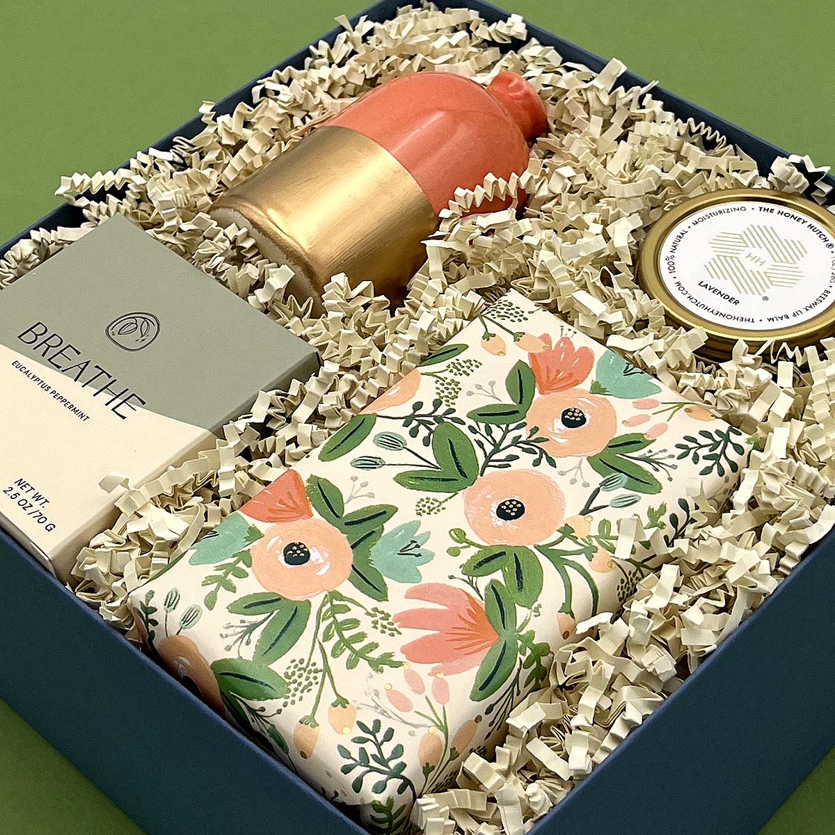 Just Because Gift Box with floral-wrapped cookies, lip balm, decorative vase, and sweet gummies