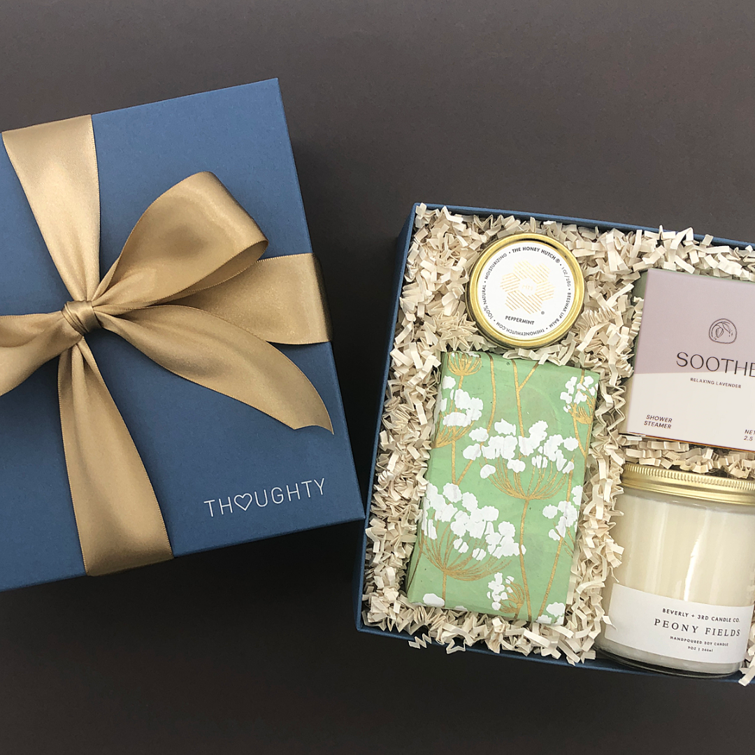 Gift for stress relief and mindfulness with candle, shower steamer, lip balm, and sweet treats