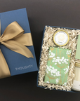 Mindful Moment Gift Box with Peony Fields candle, lavender shower steamer, peppermint lip balm, and salted caramel almond cookies.