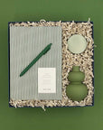 Thoughty Mint Condition gift box with sage green ceramic bud vase, Goa travel tin candle, green striped Notem notebook, and matching gel pen.