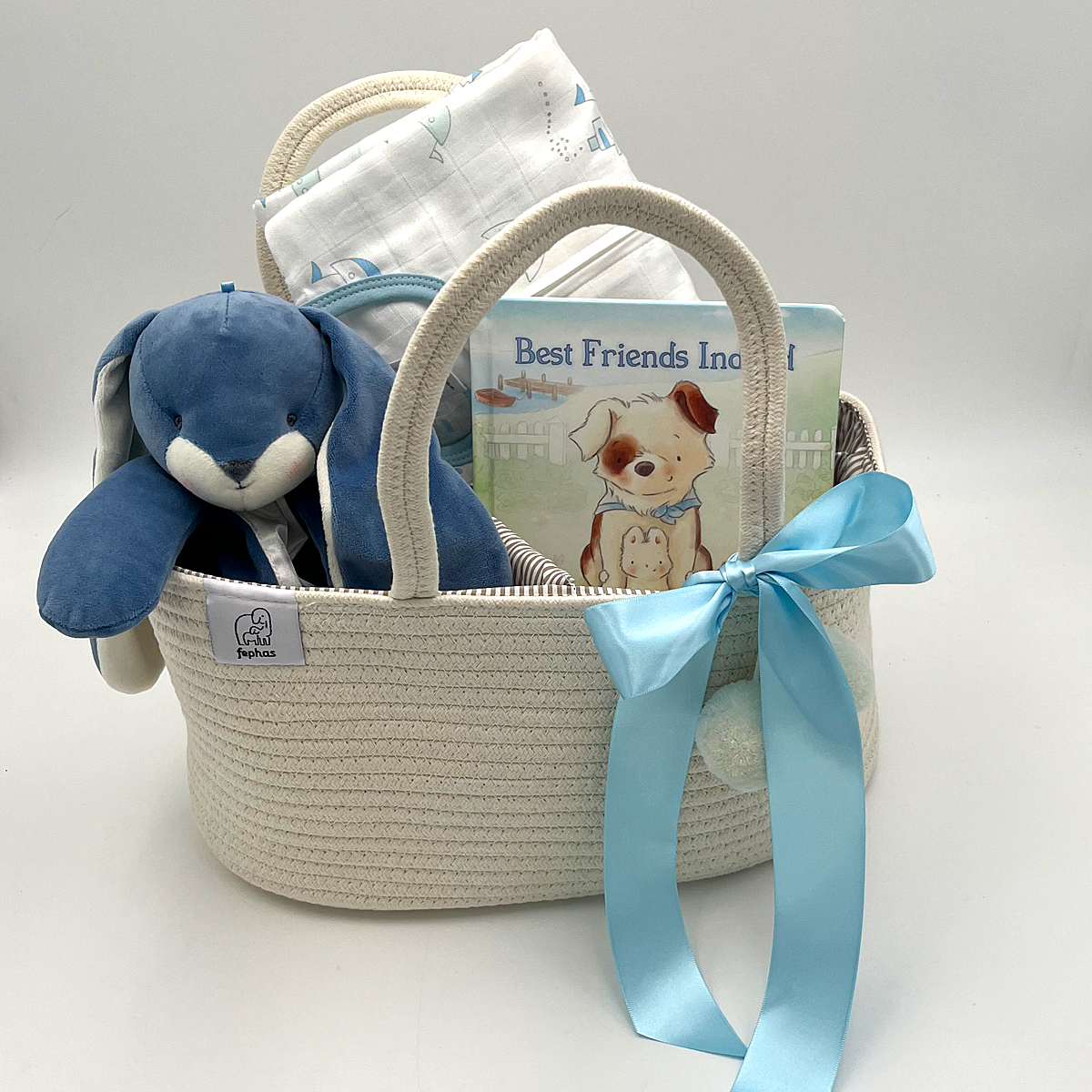 New Arrival Baby Gift with blue bunny buddy blanket, Little Ships muslin sleep sack, Best Friends board book, and rope diaper caddy