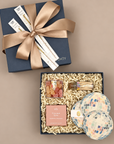 Watercolor mirror ball coasters with Bubbly Bears gummy candy in a celebratory gift box tied with a brone bow.