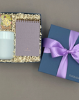 Take Note gift box with a travel tumbler, pocket notebook, and candy in a Thoughty box tied with a satin ribbon.
