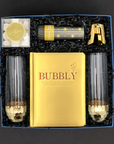 Elegant black and gold celebration gift set with champagne treats and confetti popper.