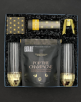 Elegant black and gold celebration gift set with champagne treats and confetti popper