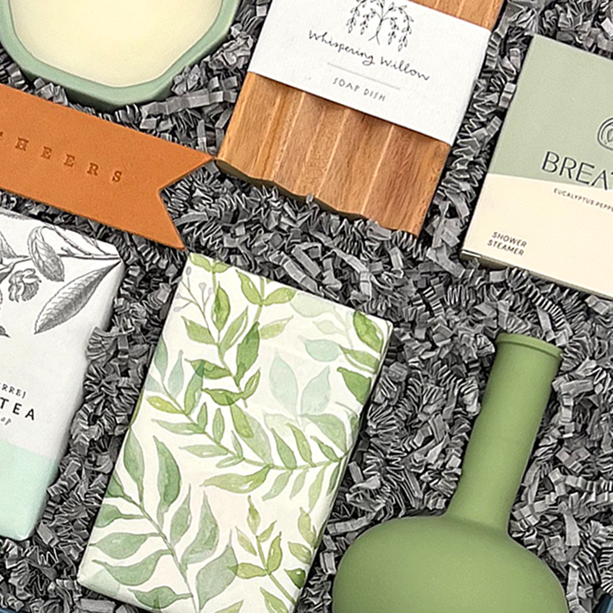 Elegant housewarming gift box with home décor, artisanal soap, candle, and sweet treats
