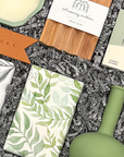 Elegant housewarming gift box with home décor, artisanal soap, candle, and sweet treats
