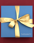 Gift box tied with satin ribbon and handwritten note card.