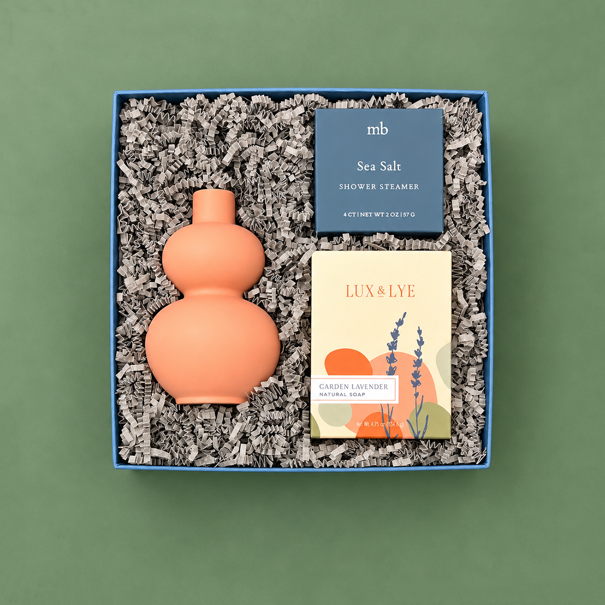 Bloom gift box with coral bud vase, garden lavender soap, and sea salt shower steamer.
