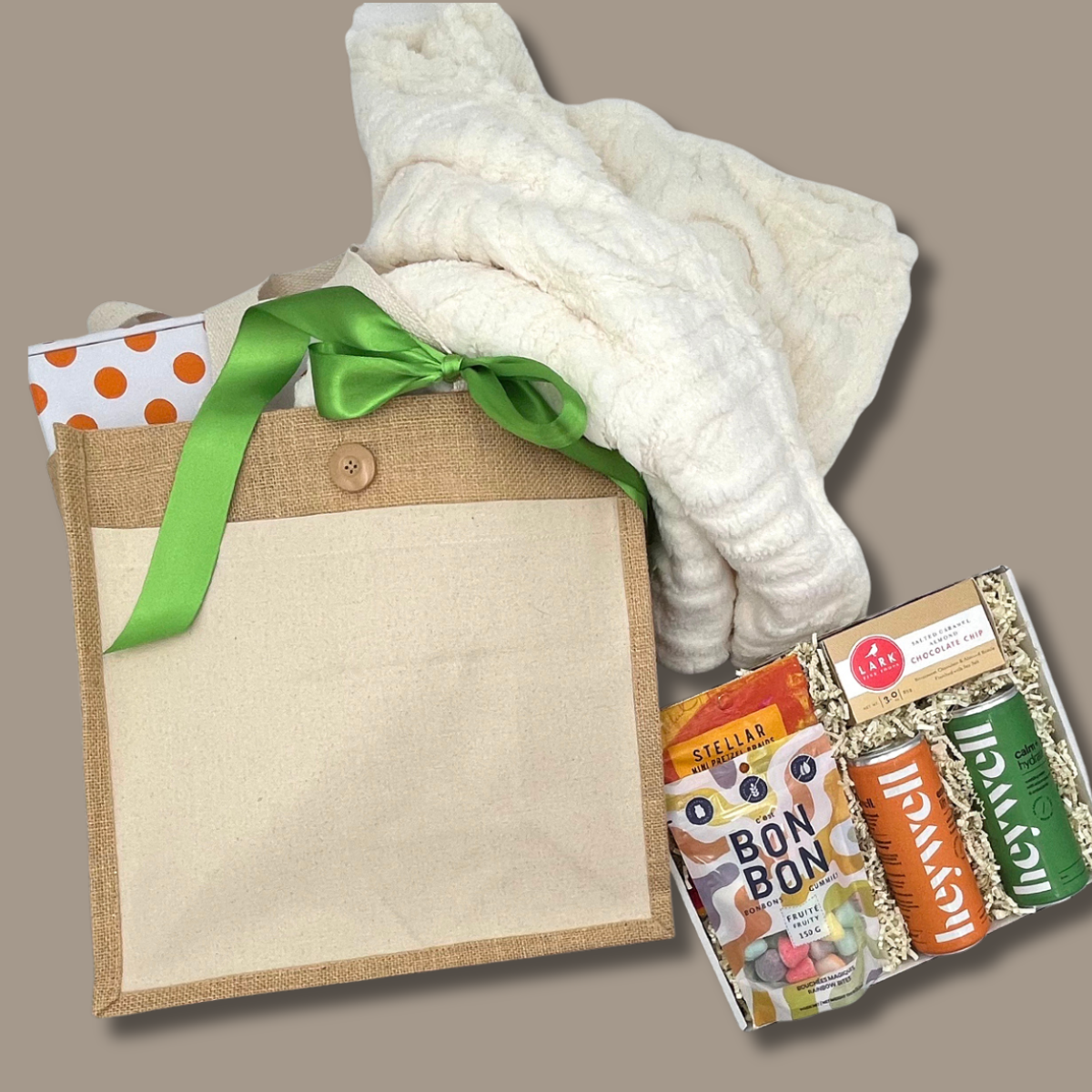 College Care package set with a white blanket, reusable tote bag and snacks