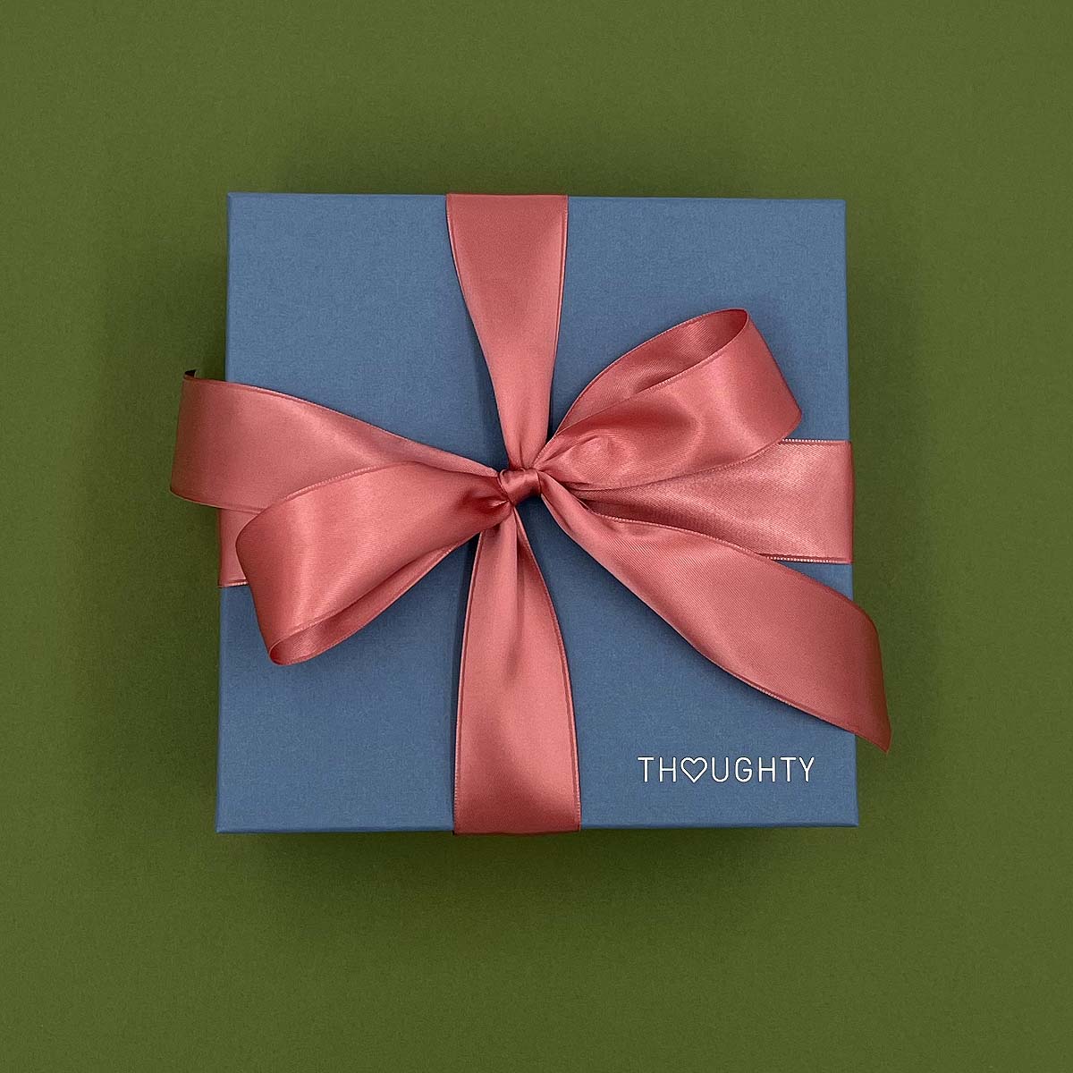 Thoughty gift box tied with a satin ribbon.