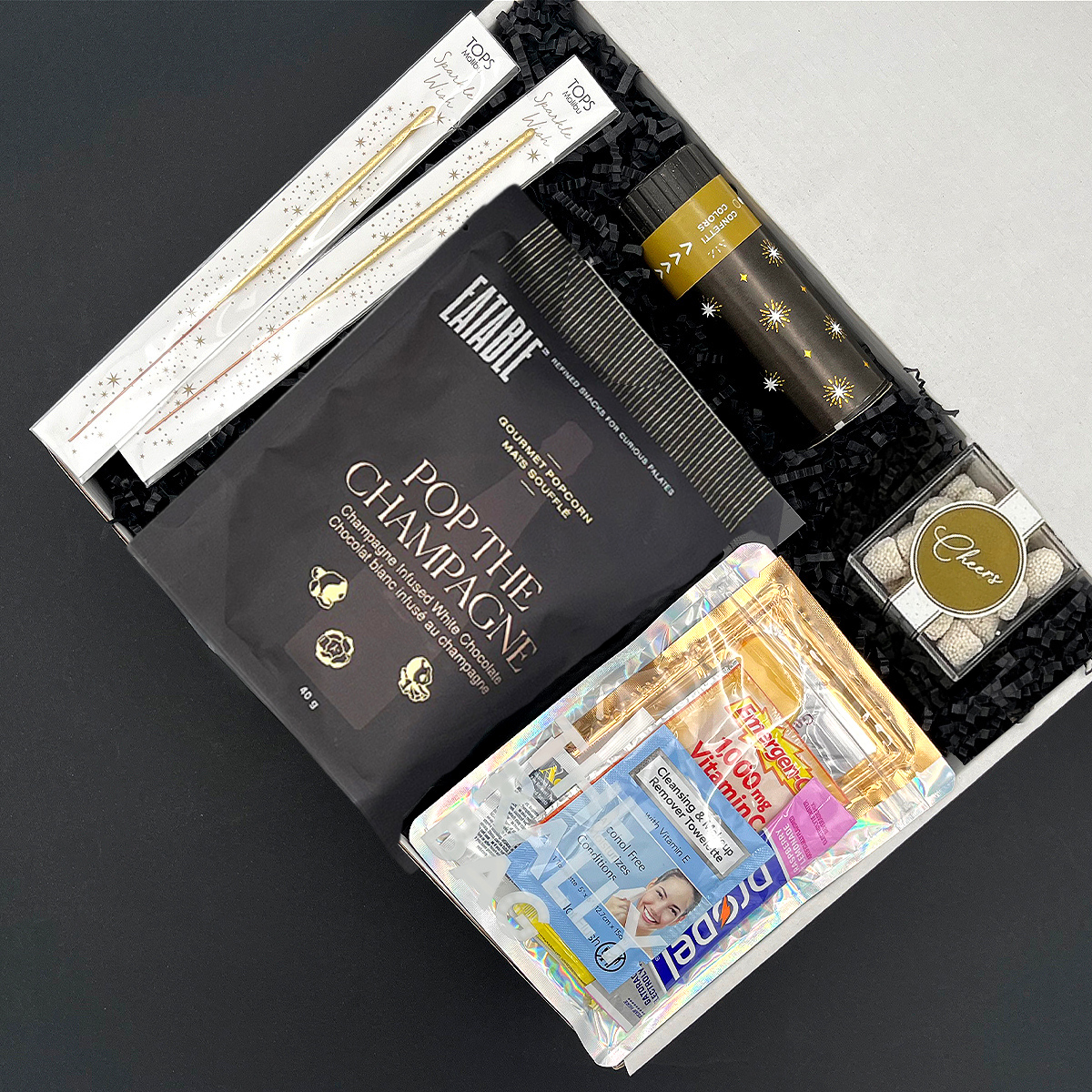 Celebration gift box with sweet treats, handover recovery kit, and party confetti