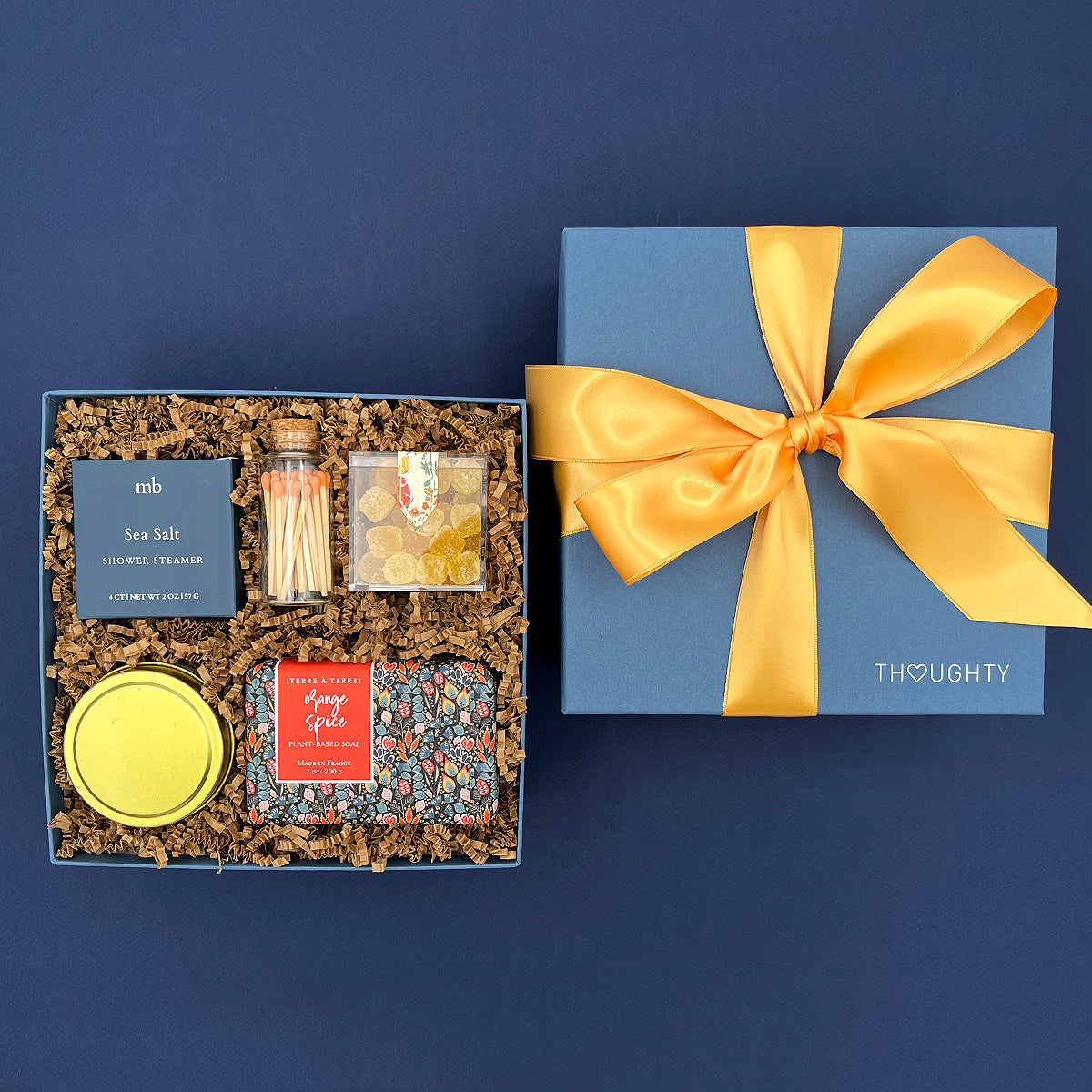 Thoughtful self care gift box with Peony Fields candle, citrus soap, sea salt shower steamer and lemon candy