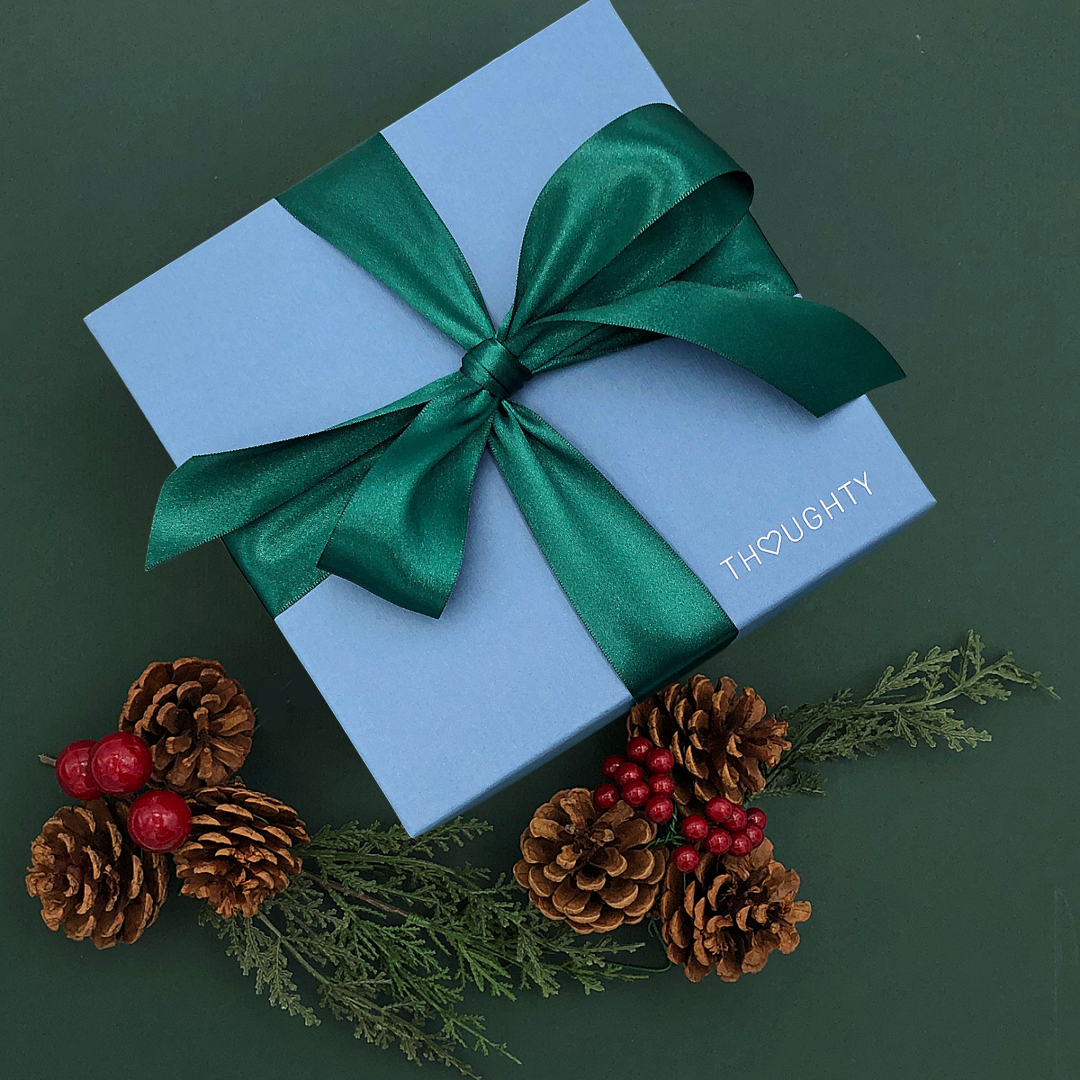 Elegant Good Tidings Gift Box tied with a satin ribbon, perfect for employees or clients.