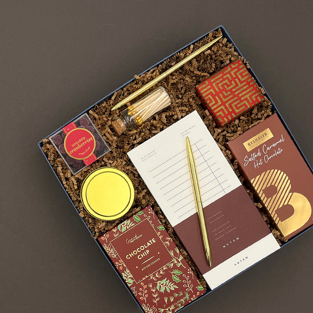Hearth Gift Box displayed with gourmet snacks, cozy comforts, and festive packaging