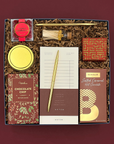 Hearth Gift Box filled with gourmet treats, cozy candle, and festive holiday accents.