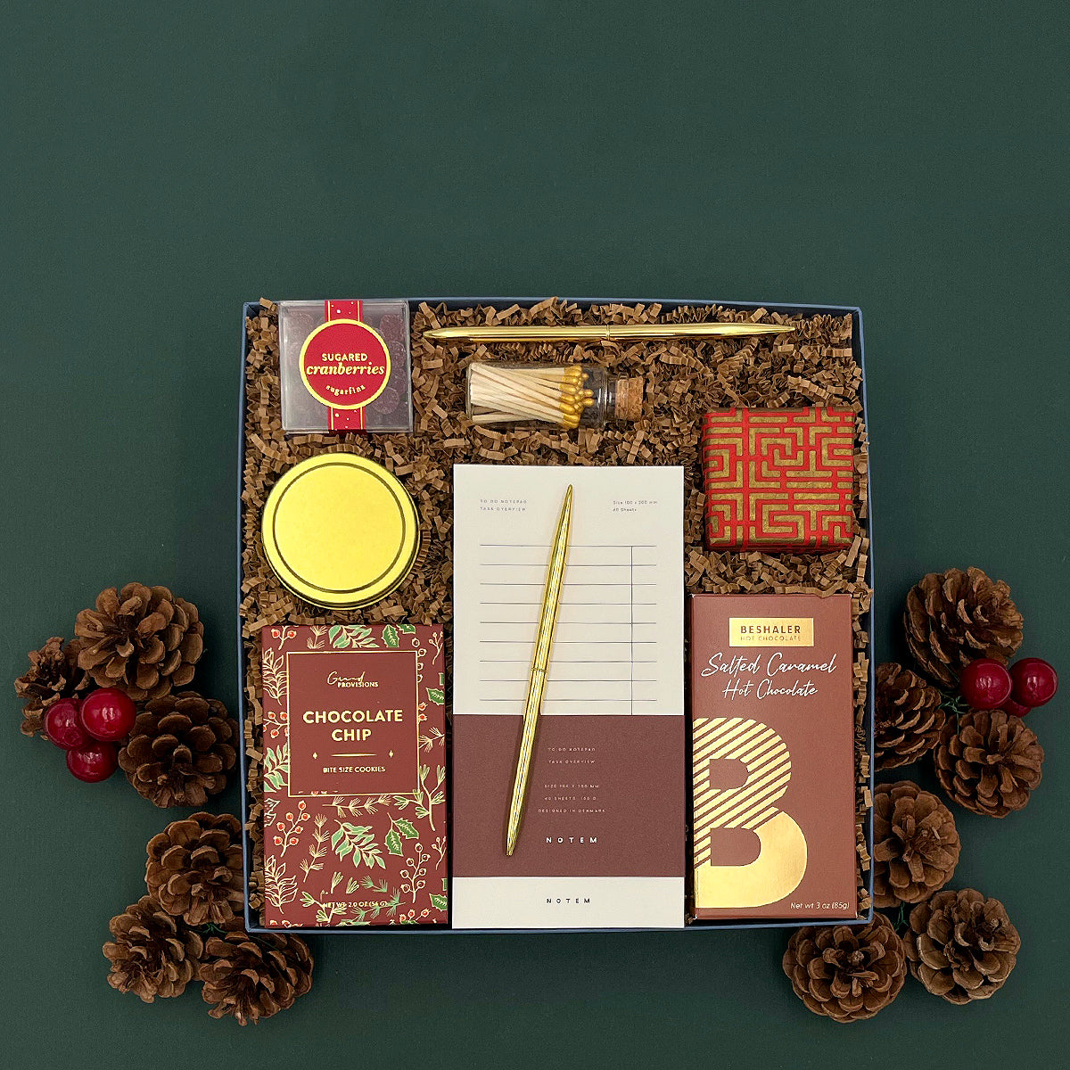 Holiday Hearth Gift Box arranged with treats, stationery, candle, and seasonal touches.