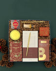 Holiday Hearth Gift Box arranged with treats, stationery, candle, and seasonal touches.