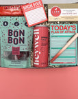 High Five Kit college student care package with sticky notes, snacks, and energy drink in a gift box