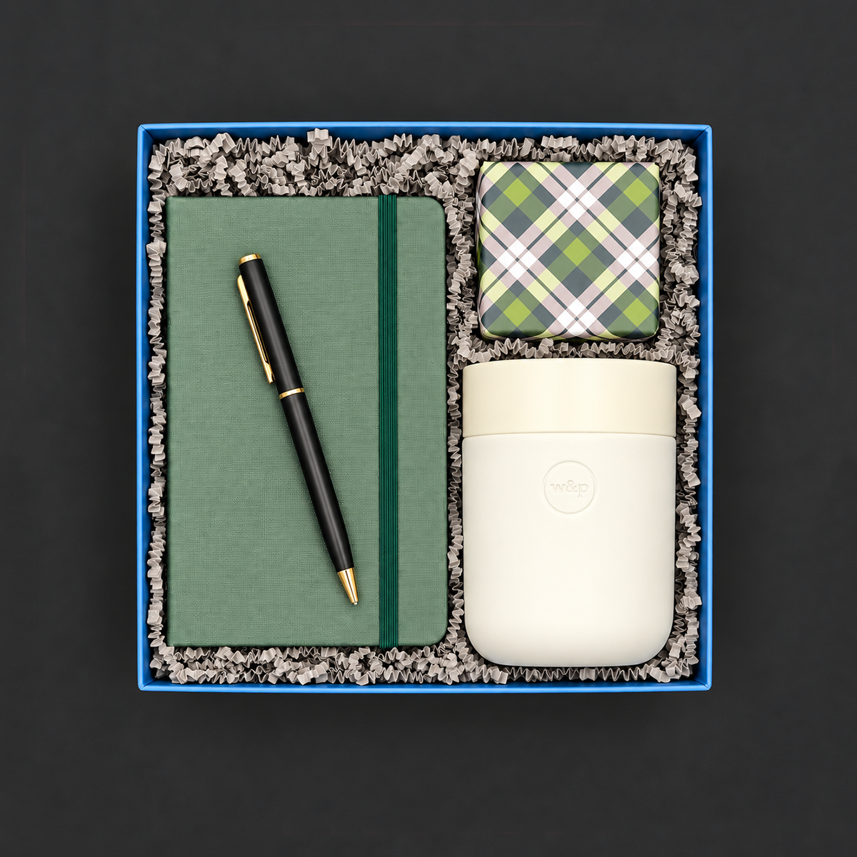 Home Office gift box with green journal, black and gold pen, travel tumbler, and colorful confetti caramels.