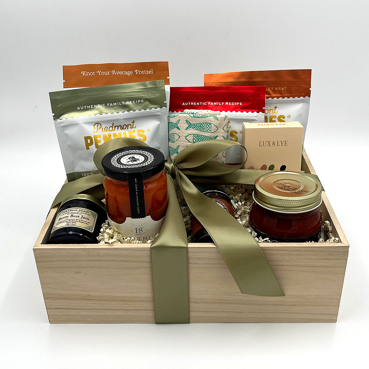 Made in NC Gift Crate with Queen City Crunch Pretzels, tomato soup, Piedmont Pennies cheese bites, honey, hand soap, marinara, jam, and kitchen towel.
