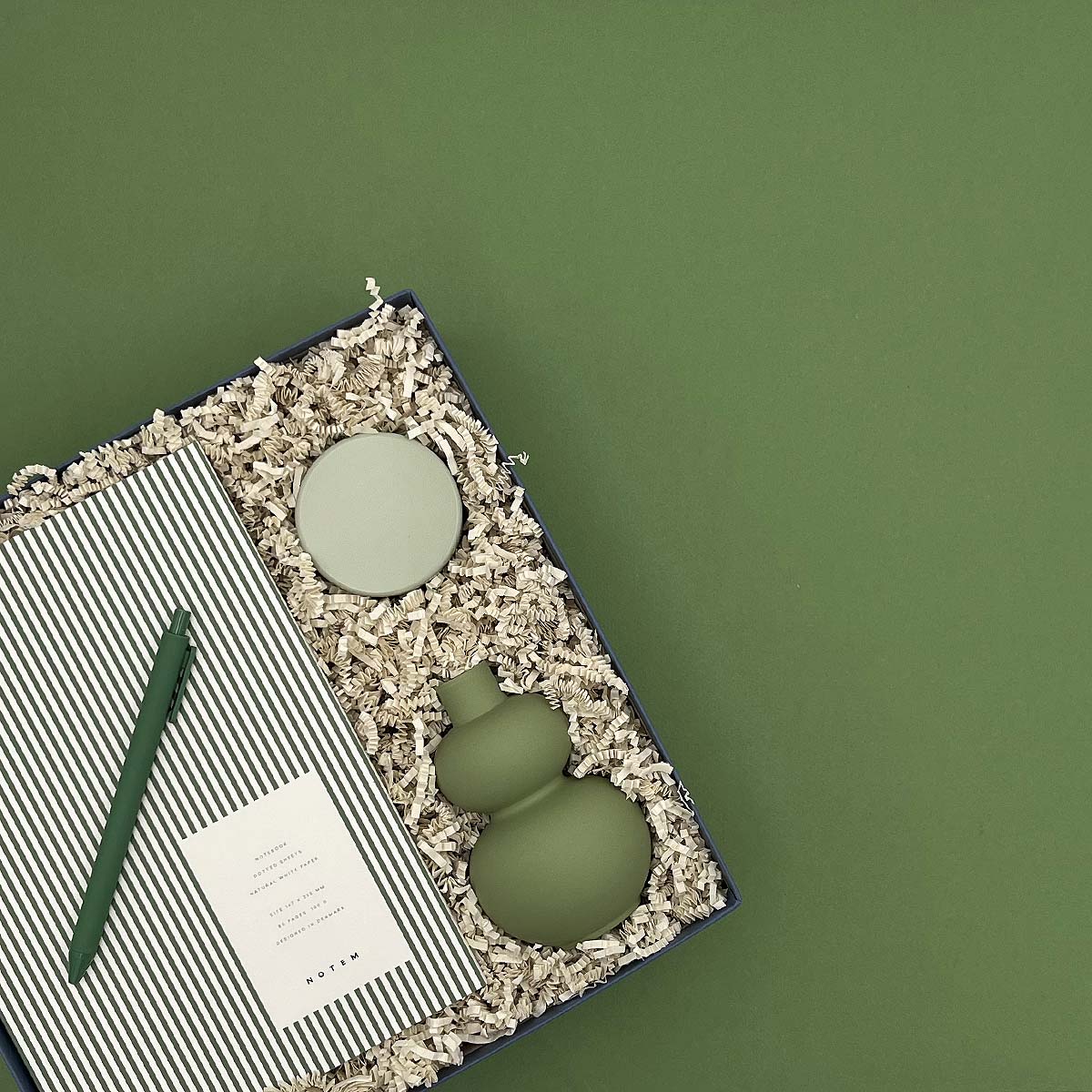 Green ceramic items on a textured surface with a green background