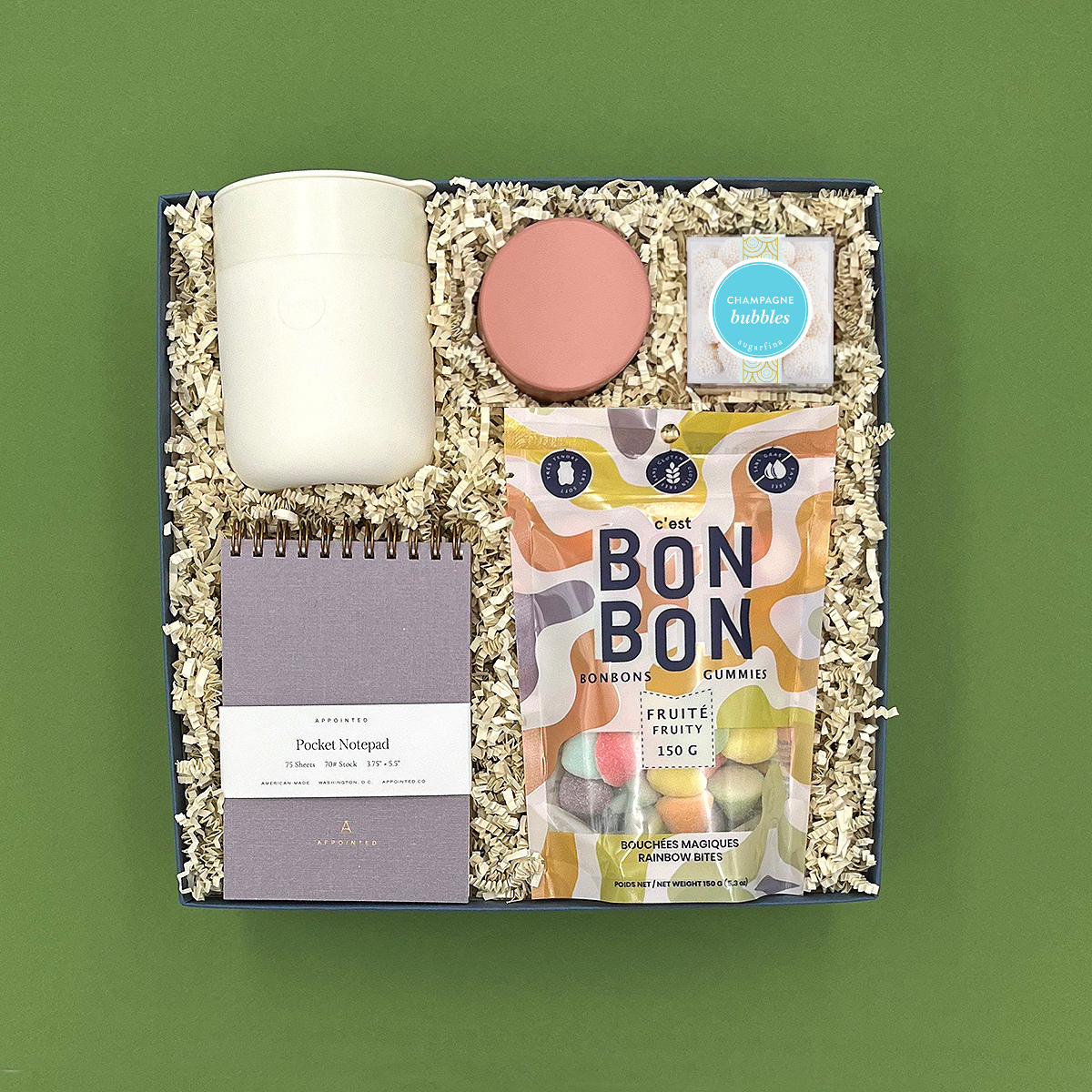 Noteworthy Gift Box with cream acrylic tumbler, Seville candle, lavender grey notebook, rainbow candy bites, and butterfly gummies