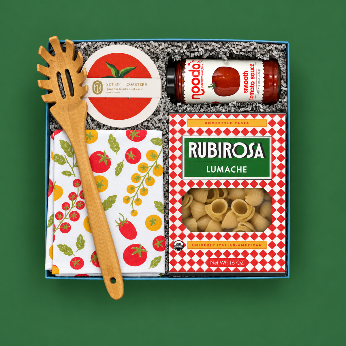 Pasta Night gift box with lumache pasta, tomato sauce, tomato kitchen towel, bamboo pasta spoon, and tomato coasters.