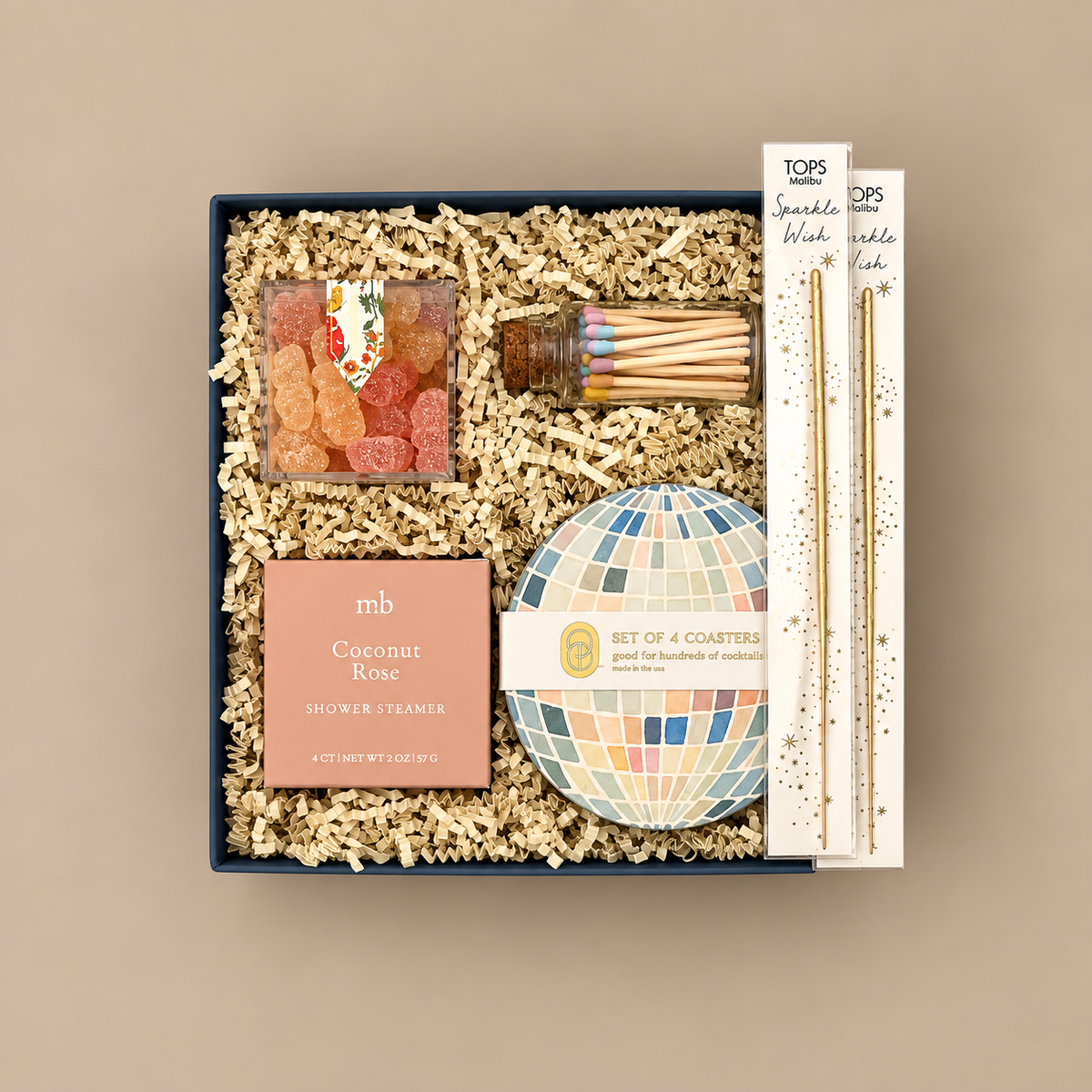Colorful congratulations gift box with watercolor disco ball coasters and celebration treats