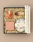 Colorful congratulations gift box with watercolor disco ball coasters and celebration treats