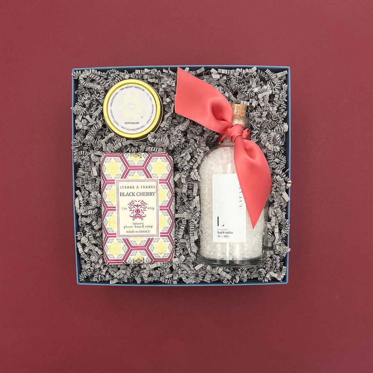 Gift set with spa products in a decorative box on a red background