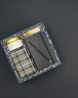 Employee and client appreciation gift with black and gold stationery, travel candle, matches, and chocolate chip cookies.