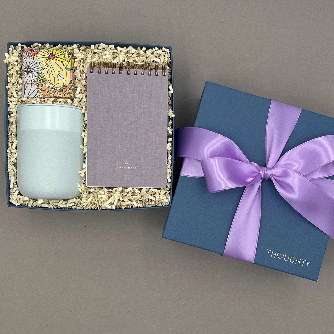 Take Note gift box with a travel tumbler, pocket notebook, and candy in a Thoughty box tied with a satin ribbon.