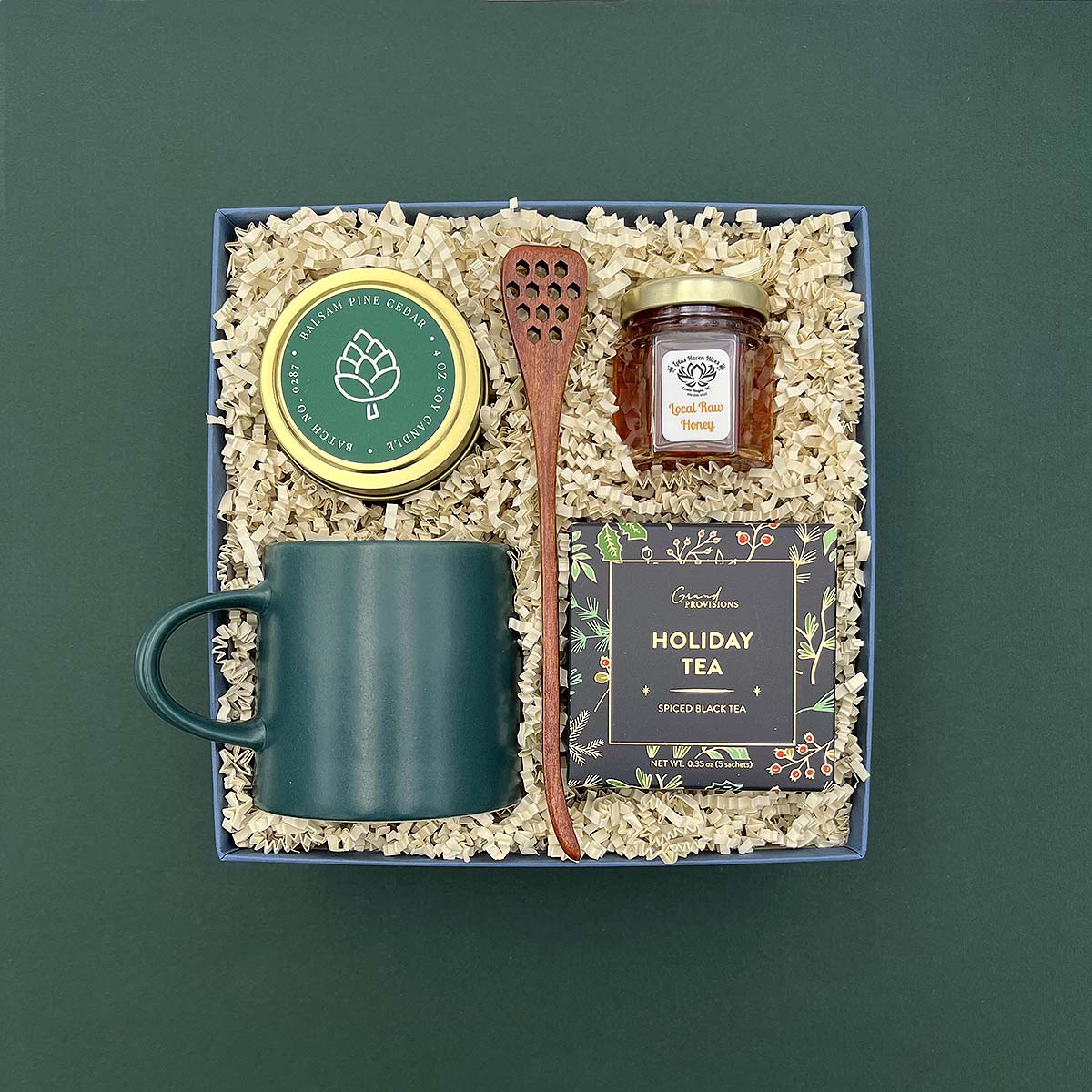 Tea Time Gift Box with holiday tea, green mug, honey, candle, and satin ribbon.