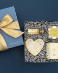 Celebrate Gift Box with white and gold vase, heart ring dish, Champagne Bubbles gummies, and Candlefish candle