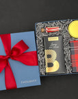 Close-up of Spicy Hot Chocolate and Ginger Snap Cookies in festive packaging.